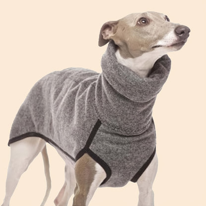 A dog wearing a sleek grey turtle neck sweater that covers its torso and front legs.