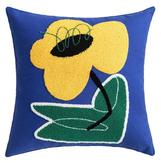 a pillowcase with an abstract design of a yellow figure on a blue flower.