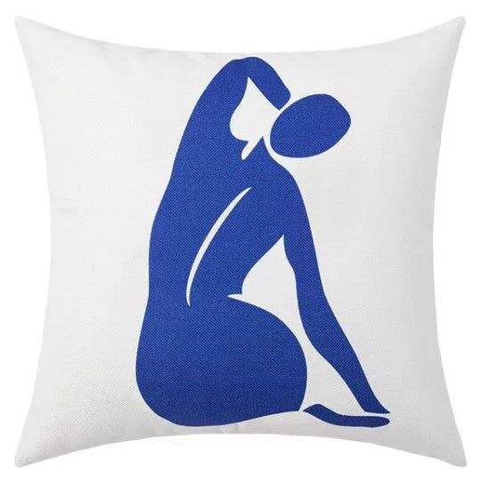 a pillowcase shows a stylized blue silhouette of a woman on a white background. 