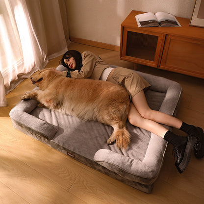 Another angle of dog and owner sleeping contentedly next to the memory foam dog bed, plushness.