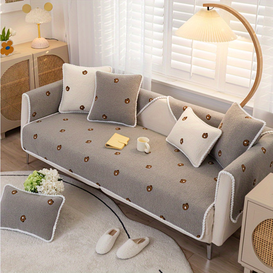 Non-slip sofa protector adorned with plush fabric in grey bear design