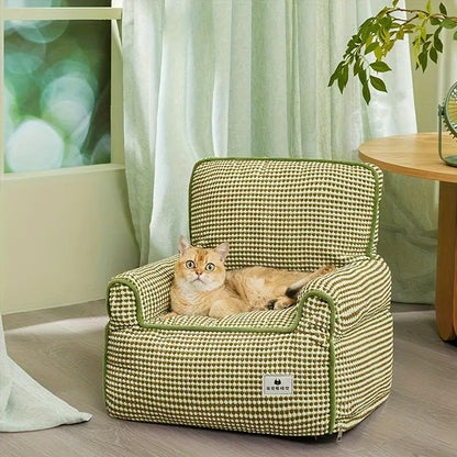 Cat relaxing on a comfortable green pet sofa.
