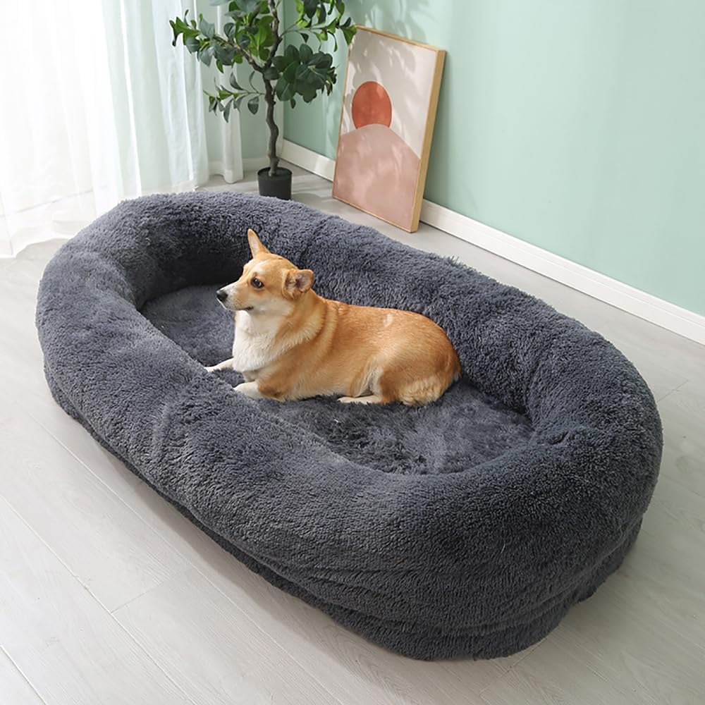 "A peaceful dog nestled in a dark grey bed, enjoying a restful sleep."