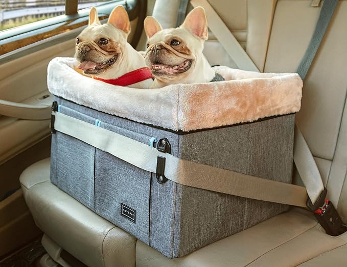 A grey booster seat containing two dogs secured on a car seat 