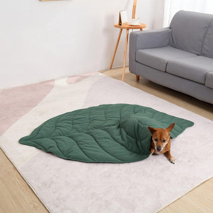 "Dog lying comfortably on a green leaf cotton pet mat on the floor."
