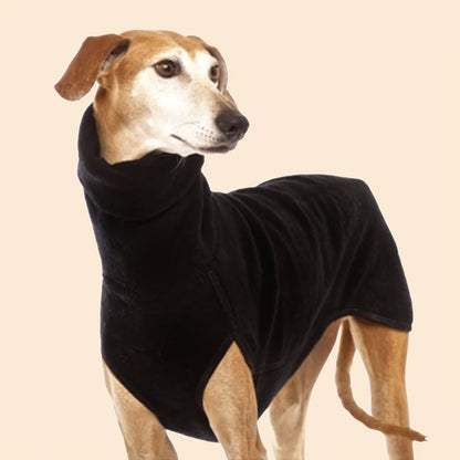 A tan  dog wearing a black turtle neck sweater that covers its body and front legs.