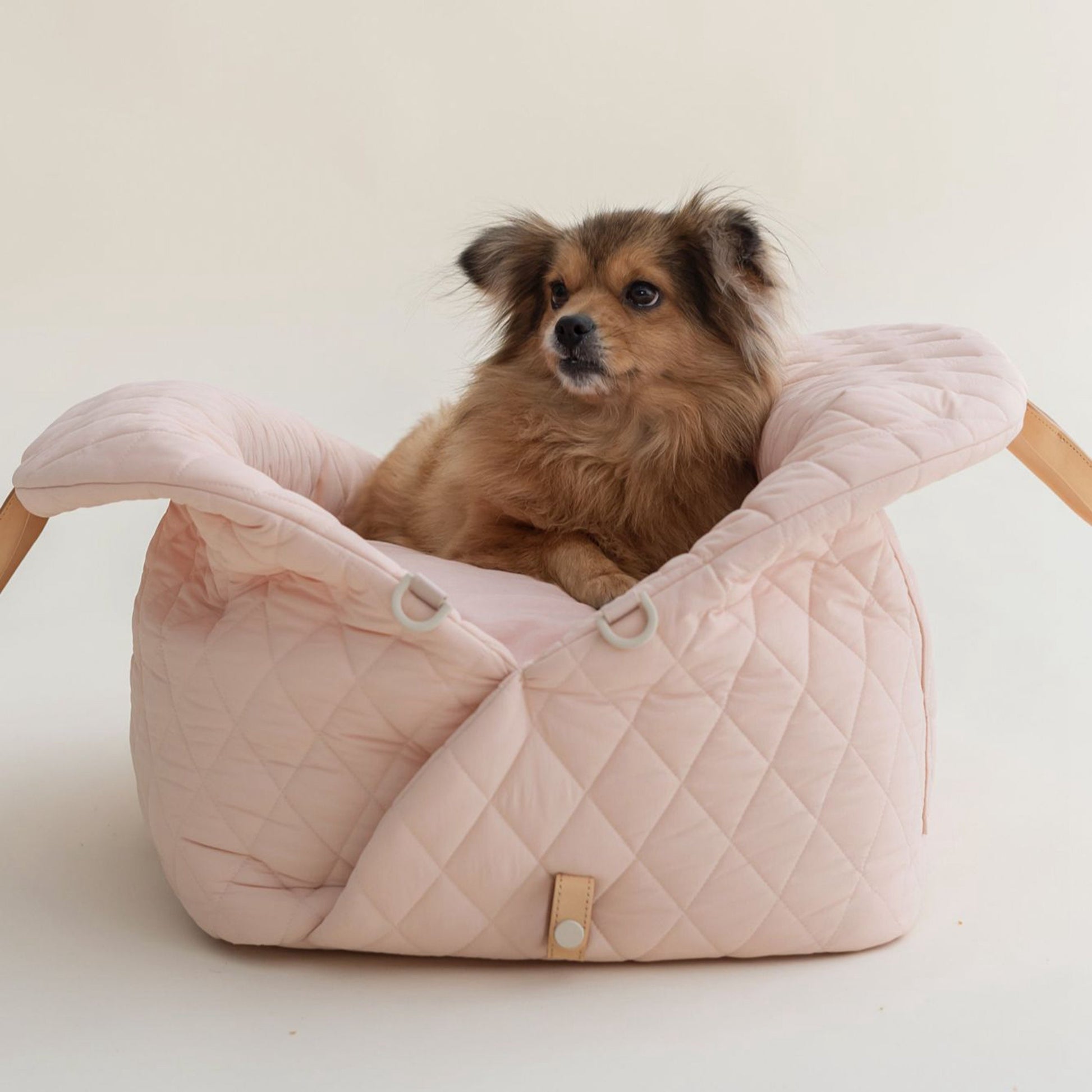 Versatile pet tote that transforms into a secure dog car seat in pink color