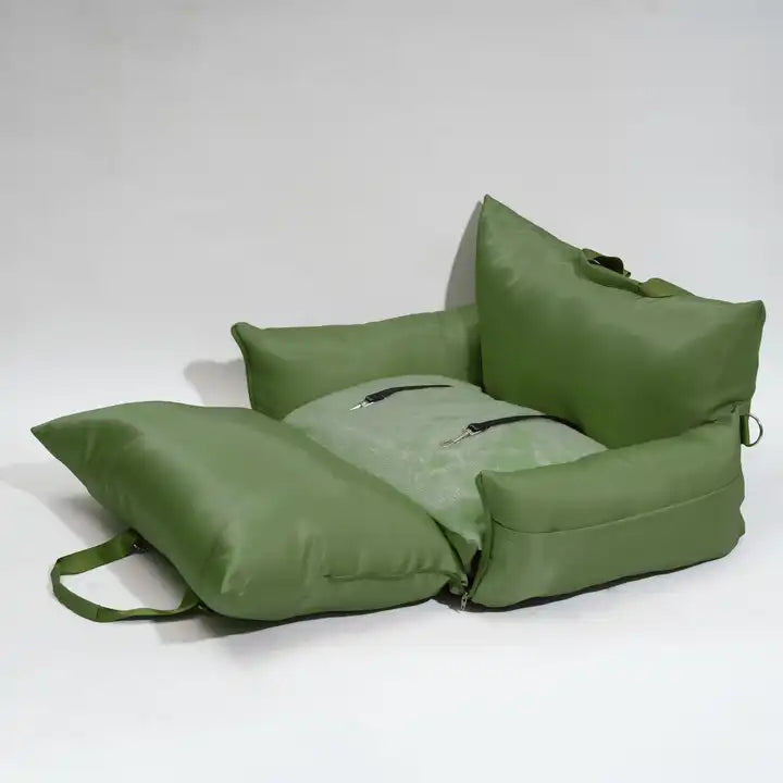 "Green travel bolster bed folded out, serving as a cozy pet bed."
