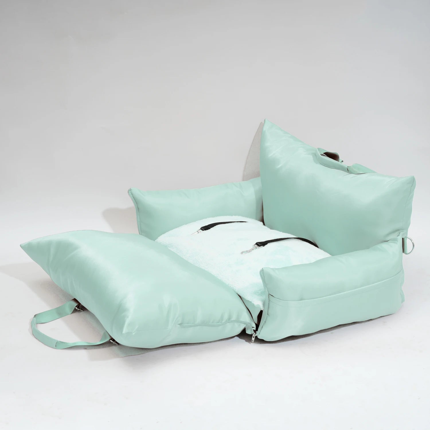 "Green travel bolster bed displayed unfolded, emphasizing space."
