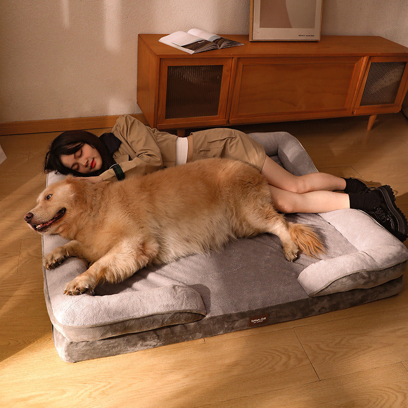 Dog and owner sleeping peacefully beside the premium memory foam bolster dog bed on the floor.