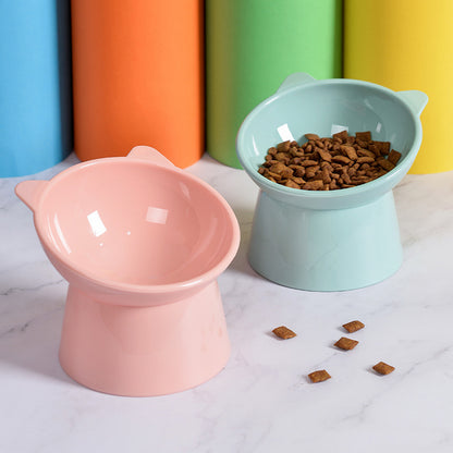 "Close-up of two ergonomic cat feeding bowls, one filled with food and the other empty.