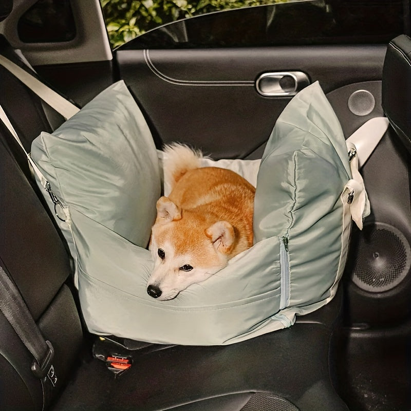 "Dog resting in a light green bolster bed in the car, looking content."
