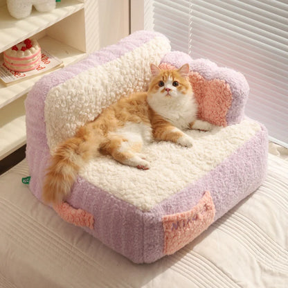 "Ginger cat sitting on a pink super soft sherpa plush fleece pet sofa, gazing at the camera."
