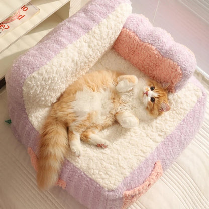 "Ginger cat lounging on its back in a pink plush fleece pet sofa, looking relaxed and content."
