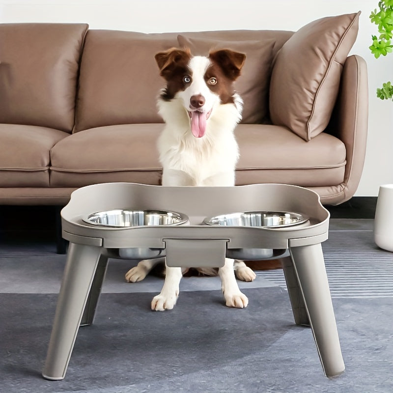 A white dog using the grey elevated dog bowls