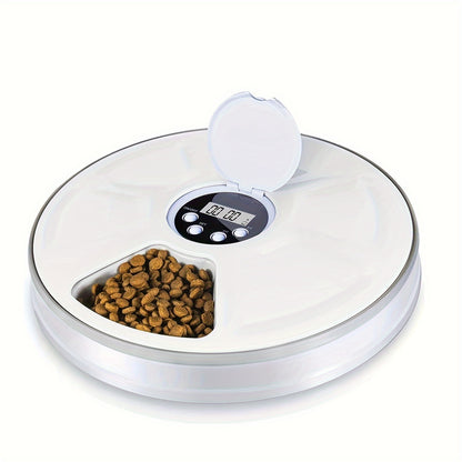  The feeder is white, round, with a clear, flip-top lid revealing a digital timer and buttons.