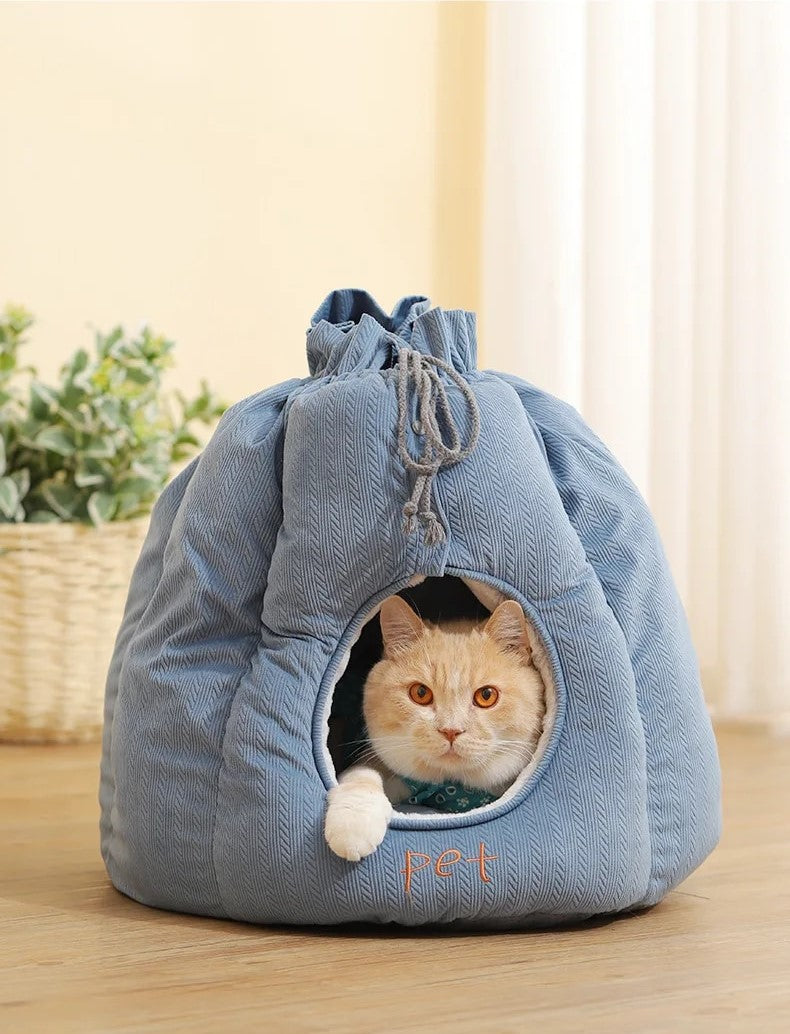 A plush cat bed resembling a cozy house, perfect for feline relaxation.