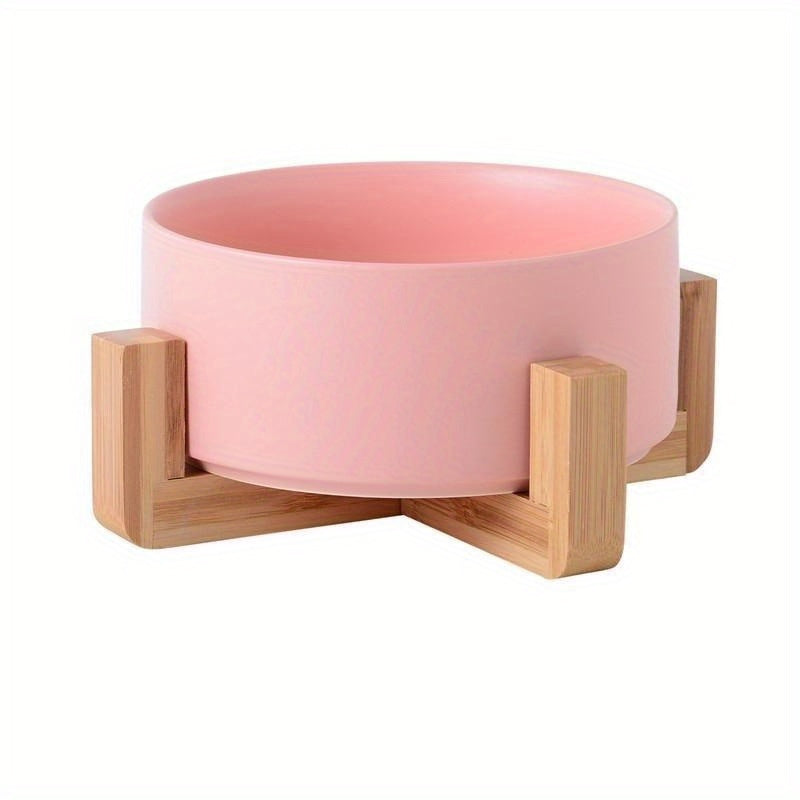 Elevated ceramic dog bowl on wooden rack in pink color