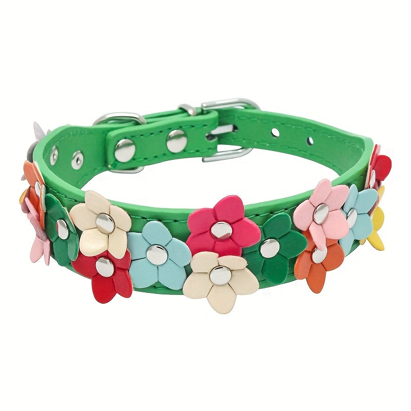 Green dog collar accented with flowers in hues of yellow, red, and blue.