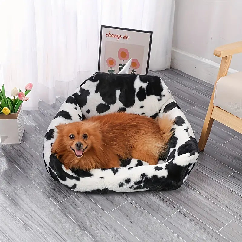 Cozy cow print pet bed for small dogs with all-season warmth.
