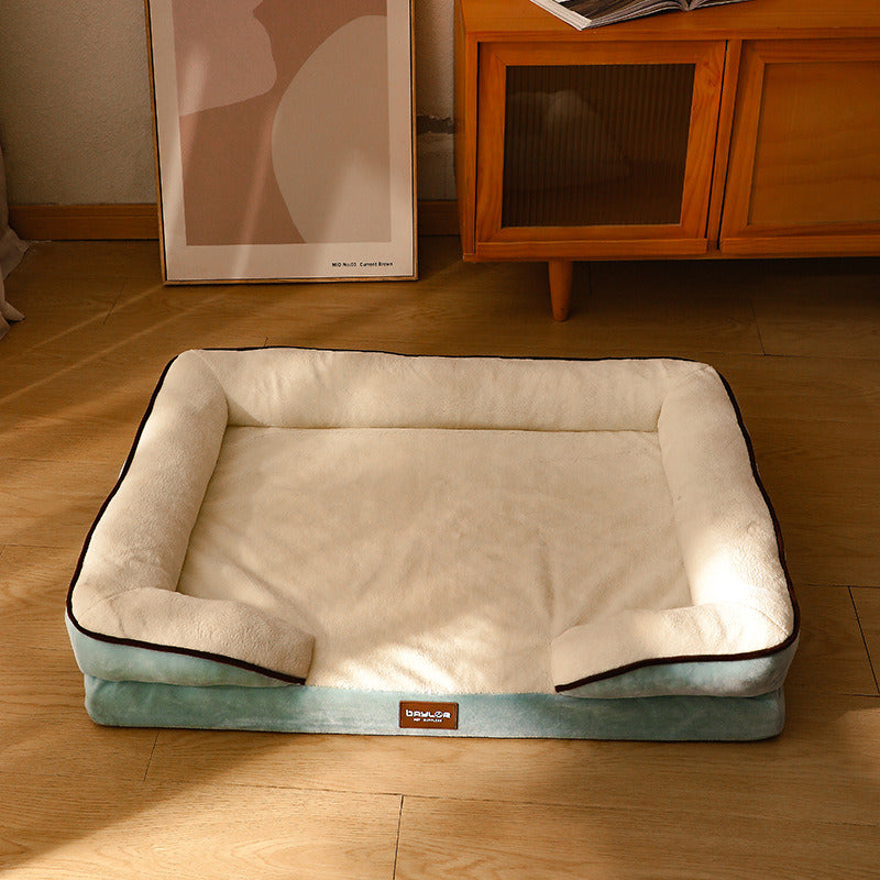 Green memory foam bolster dog bed in a beautifully furnished room.