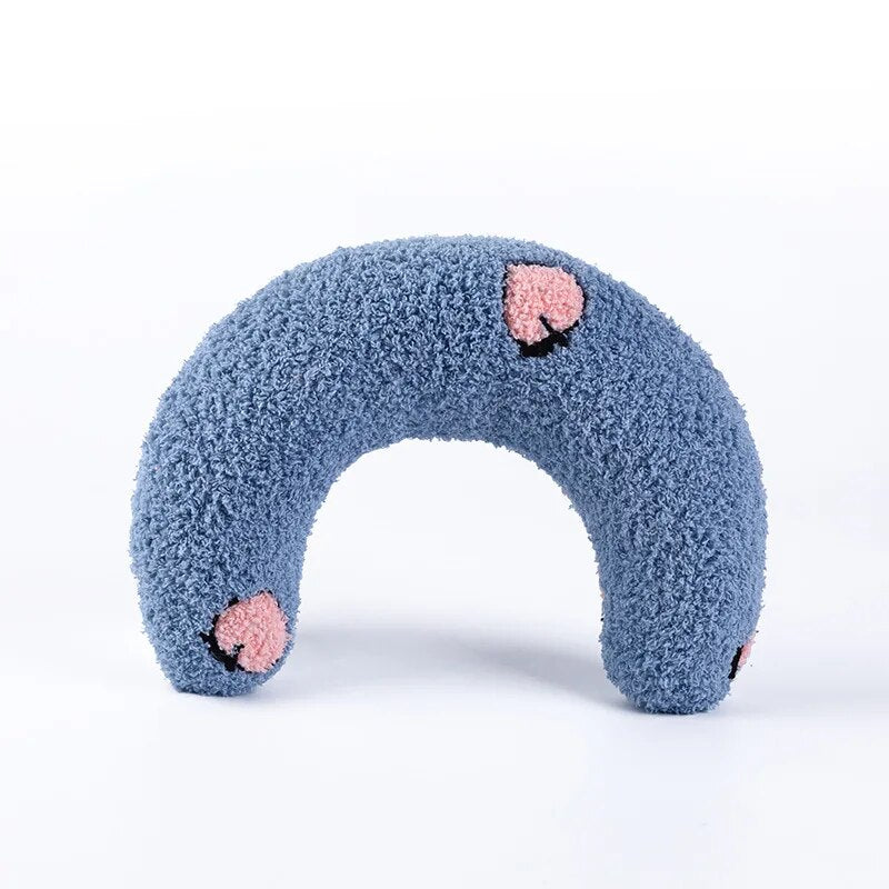 "Vibrant blue U-shaped cat pillow showcased, cozy and inviting."
