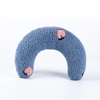 "Vibrant blue U-shaped cat pillow showcased, cozy and inviting."
