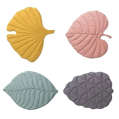 "Four quilted pet mats showcasing all leaf designs: pink, yellow, green, and grape."