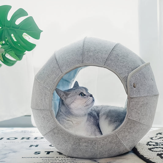 A cat inside the Interactive Cat Bed Cave