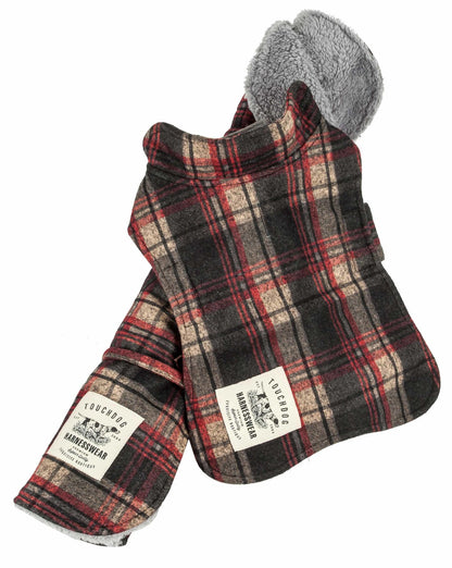 "Red Reversible tartan dog jacket alongside its matching tartan mat."